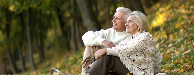 Senior couple sitting in a colourful park