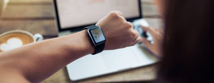 A woman checking the time on a watch.