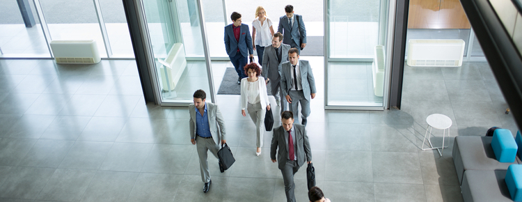 Business people walking into an office building.