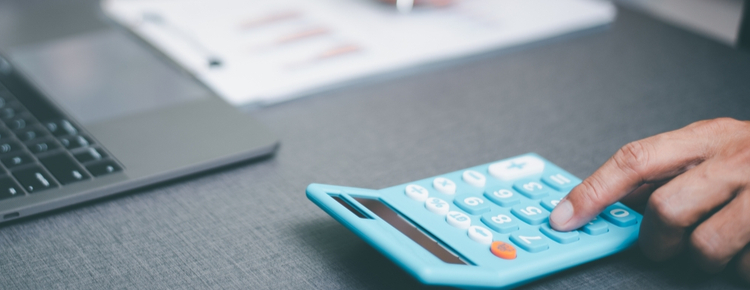 Close-up of a person using a calculator.