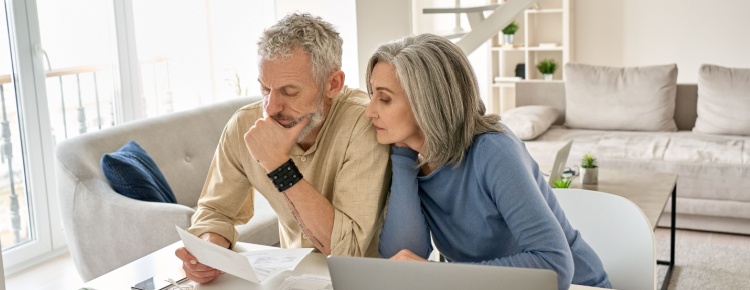 A couple looking at paperwork together in their home.