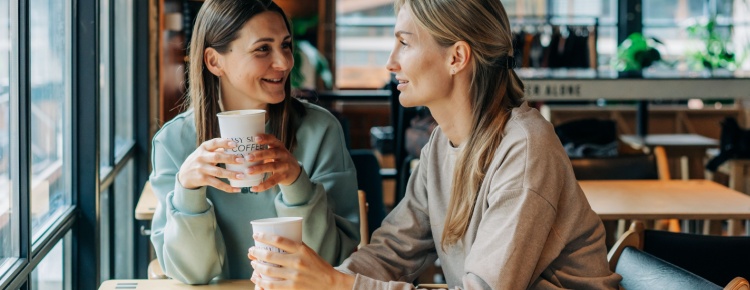 Two women talking in a coffee shop.
