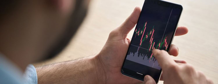 A man looking at investment performance on his phone.
