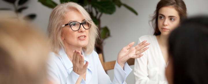 A woman talking during a work meeting.
