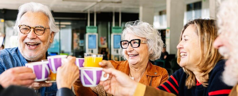 A group of people talking and drinking tea.