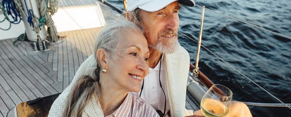 A couple sitting on a yacht deck.