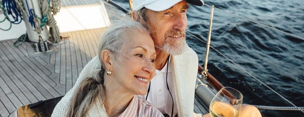 A couple sitting on a yacht deck.