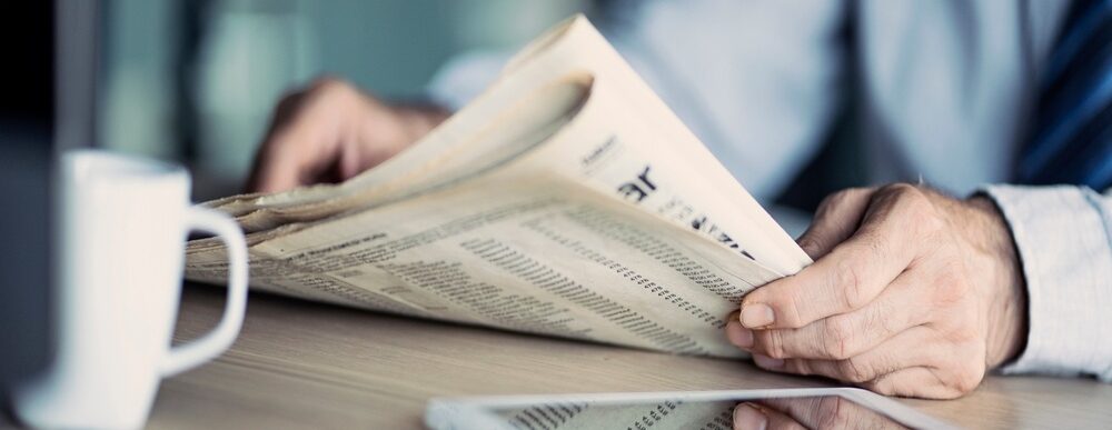 A man reading a newspaper.