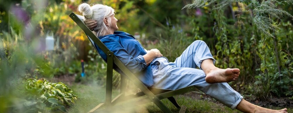 A woman relaxing in a garden.