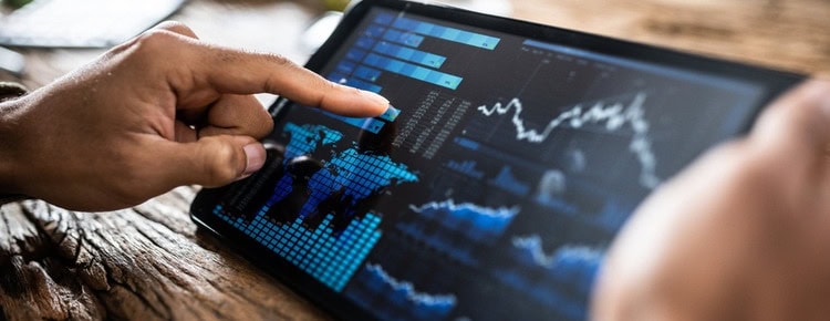 A person reviewing investment performance on a tablet.